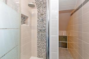 a shower with a glass door in a bathroom at La Renardière - Chambre in Férel +17 photos