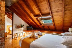 a bedroom with a bed in a room with wooden ceilings at Casa Florenta G4 in Cangas de Onís