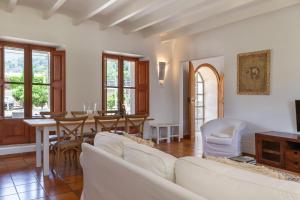 a living room with a white couch and a table at Finca Can Nou in Sóller