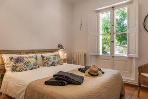 a bedroom with a bed with a hat on it at Finca Can Nou in Sóller