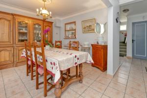 a kitchen and dining room with a table and chairs at La Renardière - Chambre in Férel