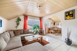 a living room with a couch and a table at Haus Fabio in Großengstingen