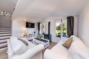 a living room with two white couches and a fireplace at Can Botana 1 in Cala de Sant Vicenc