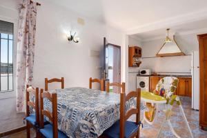 a dining room with a table and a kitchen at Las Calas de Roche in Roche +17 photos