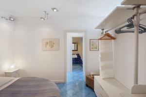 a bedroom with a bed and a hallway at Casa Il Geco Praiano in Praiano