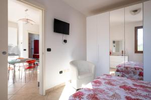 a bedroom with a bed and a table with a chair at Villa Olga in Nardò