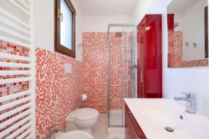 a bathroom with a toilet and a sink and a shower at Villa Olga in Nardò +19 photos