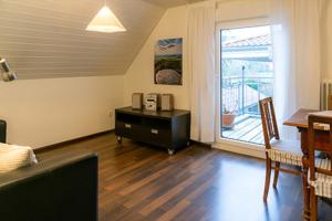 a living room with a table and a dining room at s'Krumme Gustels Hüs in Bahlingen +11 photos