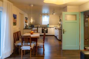 a kitchen and dining room with a table and chairs at s'Krumme Gustels Hüs in Bahlingen