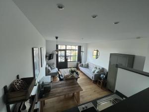 a living room with a couch and a table at Seeliebe-Reichenau in Reichenau