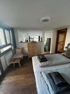 a bedroom with a bed and a dresser in it at Seeliebe-Reichenau in Reichenau