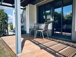 a deck with a table and chairs on a house at Seeliebe-Reichenau in Reichenau