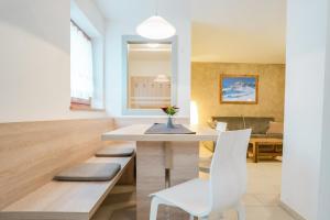 a dining room with a table and a white chair at Il Mondo di Patty 3 in Pera