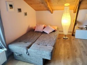 a bedroom with a couch and a lamp in a room at Altes Landhaus in Behrendorf