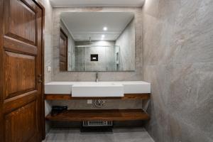 a bathroom with a white sink and a mirror at Guest House Amadryades in Karpenisi +86 photos