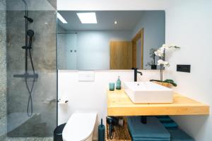 a bathroom with a sink and a shower at Kay lava in Famara +21 photos