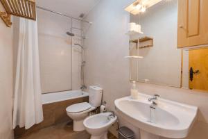 a bathroom with a toilet and a sink and a tub at Hygee in San Javier +21 photos