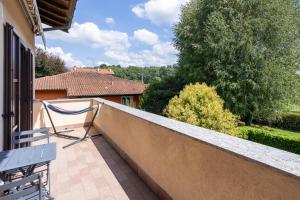 a balcony with a bench and a view of a house at Rocca Lake House in Angera