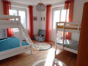 a room with two bunk beds and a rug at Gîte des Bruyeres in Beynat