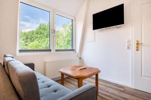 a living room with a couch and a table at Die Alter Schwede Wohnung 3 in Vechta
