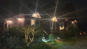 a house lit up at night with lights at Spring Garden Wando in Wando