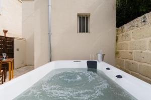 a bath tub with water inside of it at Corte Cochlea Lu Sciardinu Suite in Cannole