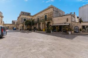 an empty street in a town with buildings at Corte Cochlea Lu Sciardinu Suite in Cannole +18 photos