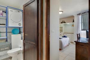 a bathroom with a toilet and a room with a bed at El Almendro in Puntagorda +14 photos
