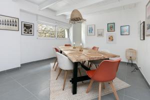 a dining room with a wooden table and chairs at Maison et Bonheur in Batz-sur-Mer