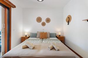 a bedroom with a large bed with two pillows on it at Casa Relax Marine in Costa Del Silencio +27 photos