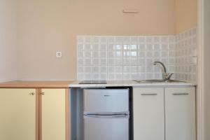 a kitchen with a sink and a dishwasher at Giorgio studios-apartments 2 in Nikiana