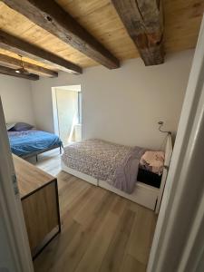a bedroom with a bed and a mirror at Domaine avec vue cirque du Levancou in Saint-Georges-de-Luzençon