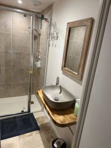 a bathroom with a sink and a shower at Domaine avec vue cirque du Levancou in Saint-Georges-de-Luzençon +35 photos