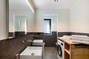 a bathroom with a sink and a washing machine at Valgrisa Mountain Lodges 2 in Valgrisenche +24 photos
