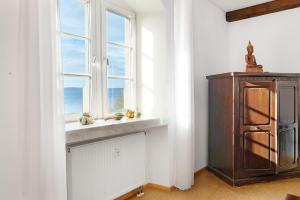 a kitchen with a window and a wooden cabinet at Zeughaus Ferienwohnung in Überlingen