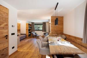 a dining room and living room with a table and chairs at Valgrisa Mountain Lodges 2 in Valgrisenche