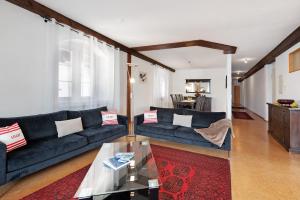 a living room with a couch and a table at Zeughaus Ferienwohnung in Überlingen