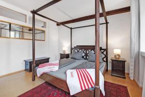 a bedroom with a canopy bed and two night stands at Zeughaus Ferienwohnung in Überlingen