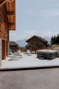a patio with two chairs and a pool table at Chalet Salt Lake in La Toussuire