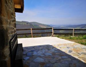 a stone patio with a view of the mountains at Casa Rural El Picón in Entrambasaguas