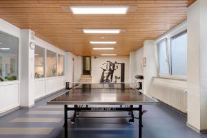 a ping pong table in the middle of a room at Schwarzwald-Kitz mit Pool und Sauna in Lenzkirch
