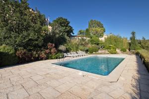 a swimming pool with chairs in a yard at Casa Espigol in El Bruc
