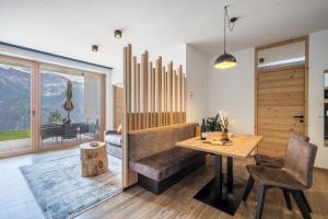 a living room with a table and a couch at Paflur Lodges Bergtraum in Lasa +11 photos