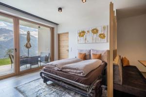 a bedroom with a bed and a large window at Paflur Lodges Bergtraum in Lasa