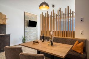 a dining room with a wooden table and chairs at Paflur Lodges Bergtraum in Lasa