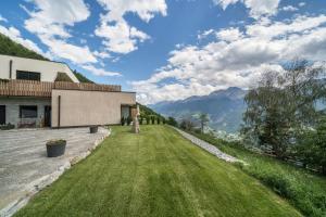 a house on a hill with a grass yard at Paflur Lodges Bergtraum in Lasa