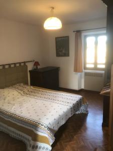 a bedroom with a bed and a window at Gîte Du Cayrou in Bournazel