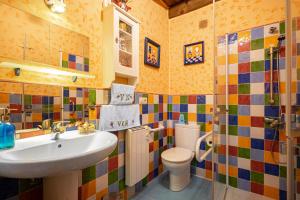 a bathroom with a sink and a toilet at Nogueira in Vega de Logares +30 photos