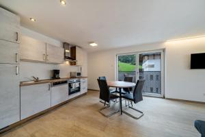 a kitchen and dining room with a table and chairs at Ferienwohnung Lamm 2 in San Valentino alla Muta