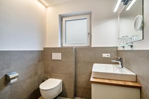 a bathroom with a toilet and a sink and a window at Ferienwohnung Lamm 2 in San Valentino alla Muta +10 photos